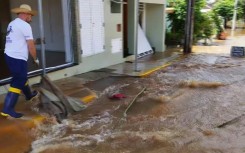 Residents in the town of Roca Sales clean flooded streets on November 19, 2023 after heavy rains hit southern Brazil leaving at least six dead, according to authorities
