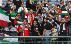 Supporters waved Palestinian flags at the game against Australia in Kuwait City