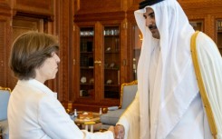 Emir Sheikh Tamim bin Hamad al-Thani welcomes French Foreign Minister Catherine Colonna at the Royal Palace in Doha