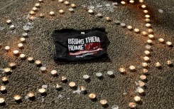 Candles arranged in a Star of David shape are lit at a gathering in Tel Aviv calling for the release of the hostages