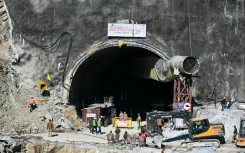 Rescue personnel work at the mouth of the Silkyara tunnel on Friday