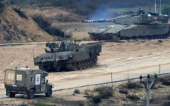 Israeli military vehicles manoeuver near near the Gaza border