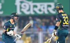 Australia captain Matthew Wade (L) celebrates with Glenn Maxwell after winning the third Twenty20 international cricket match against India in Guwahati
