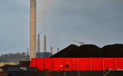 A barge carries coal to the dock next to the Suralaya coal-fired power plant in Cilegon, in Indonesia's Banten province