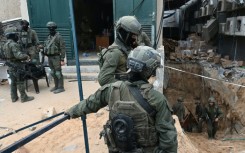 --PHOTO TAKEN DURING A CONTROLLED TOUR AND SUBSEQUENTLY EDITED UNDER THE SUPERVISION OF THE ISRAELI MILITARY-- Israeli troops surround what the army says is the entrance to a tunnel dug by Hamas militants inside the Al-Shifa hospital complex