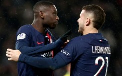 Paris Saint-Germain's Randal Kolo Muani (L) celebrates his winning goal