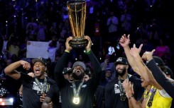 LeBron James celebrates with teammates after capturing the NBA Cup with a victory over the Indiana Pacers in the final of the league's first-ever in-season tournament