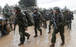 Israeli soldiers prepare to enter the Gaza Strip, near the border area in southern Israel