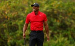 Tiger Woods reacts to a chip-in birdie by his 14-year-old son Charlie on the ninth green during the final round of the PNC Championship