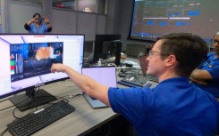 Jet Propulsion Laboratory team members react to high-definition cat video sent from a spaceship 19 million miles away