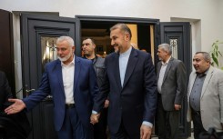 Qatar-based Hamas leader Ismail Haniyeh (L) welcomes Iranian Foreign Minister Hossein Amir Abdollahian (C), in Doha