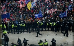 Police hold back supporters of US president Donald Trump outside the US Capitol on January 6, 2021