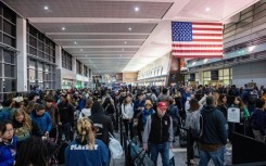 Travelers wait in the security line in Terminal A at Boston Logan International Airport in Boston, Massachusetts on December 21, 2023