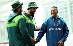Australia's Usman Khawaja (R) shares a joke with Pakistan's Hasan Ali (L) and Shan Masood (C) at the Melbourne Cricket Ground
