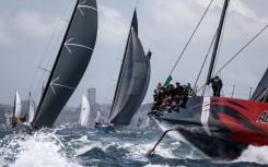 Favourite Andoo Comanche (R) competes during the start of the annual Sydney to Hobart yacht race
