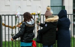 People tied flowers to the railing outside the family's flat on Tuesday