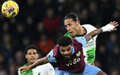 South Africa-born Burnley forward Lyle Foster (C) in a goalmouth tussle against Liverpool on December 26, 2023.   