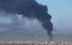 Smoke billows over the Gaza Strip on Friday amid continuing battles between Israel and the militant group Hamas