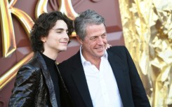 Timothee Chalamet (L) and Hugh Grant attend the Los Angeles premiere of Warner Bros.' 'Wonka' on December 11, 2023 