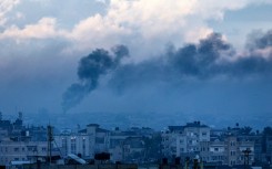 A picture taken from Rafah shows smoke billowing over Khan Yunis during an Israeli bombardment on Tuesday