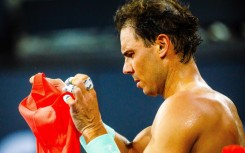 Spain's Rafael Nadal changes his shirt as he takes a break at the Brisbane International