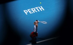 Poland’s Iga Swiatek serves against China’s Zheng Qinwen at the United Cup
