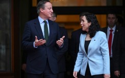 Britain's Foreign Secretary David Cameron (L) met with Kosovo President Vjosa Osmani in Pristina