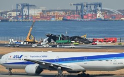All 367 passengers and 12 crew on board the Japan Airlines plane escaped down emergency slides