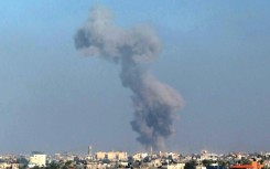 Smoke billows following Israeli strikes on Khan Yunis, seen from Rafah