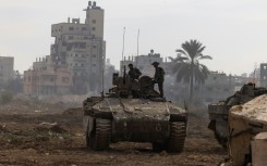 This picture, taken during a media tour organised by the Israeli military on January 8, 2024, shows troops operating in the central Gaza Strip, amid continuing battles between Israel and the Palestinian militant group Hamas