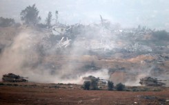 Israeli tanks roll through the central Gaza Strip on Tuesday