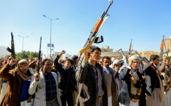 Huthi fighters brandish weapons during a march in solidarity with Palestinians in Yemen's Huthi-controlled capital Sanaa