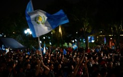 Thousands of supporters gathered to await the ceremony, waving flags, after some earlier protested the delays outside Congress