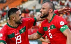 Romain Saiss (R) celebrates scoring for Morocco with Youssef En-Nesyri
