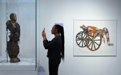 A statue stolen from a Congolose chief stands in the museum as "A Symbol of Stolen Art" as part of an exhibition highlighting the colonial-era plunder