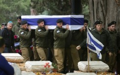Israeli troops carry the coffin of fellow soldier Hadar Kapeluk during his funeral in the Mount Herzl cemetery in Jerusalem