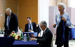 ECB president Christine Lagarde (R) and US Fed chief Jerome Powell (second right) have presided over interest rate hikes aimed at taming inflation