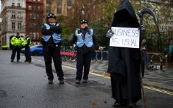 Watched by police, British environment activists take part in a London demonstration