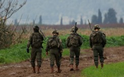 Israeli soldiers patrol an area close to the border with Lebanon after Hezbollah said it carried out a drone attack