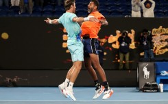 India's Rohan Bopanna (R) and Australia's Matthew Ebden celebrate after winning the Australian Open men's doubles final