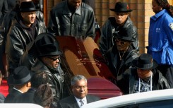 The coffin of Run-DMC's Jam Master Jay, the rapper born Jason Mizell, is carried out of a cathedral in Queens, New York, after his funeral in November 2002