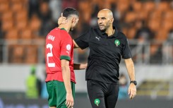 Achraf Hakimi is comforted by coach Walid Regragui after Morocco were knocked out of the Cup of Nations on Tuesday