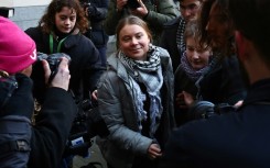 Swedish environmental activist Greta Thunberg (C) arrives with other activists at Westminster Magistrates Court in London for the first day of her trial
