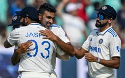 India's Ravichandran Ashwin celebrates after taking his 500th wicket, that of England's Zak Crawley, during the second day of the third cricket Test in Rajkot