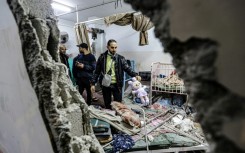 People inspect damage to a room following Israeli bombardment at Nasser hospital in Khan Yunis on December 17, 2023