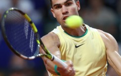 Moving on: Carlos Alcaraz returns the ball to Andrea Vavassori 