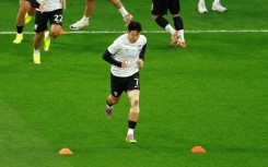 Captain Son Heung-min, his fingers bandaged, warms up ahead of South Korea's semifinal loss to Jordan at the Asian Cup
