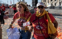 People flee after shots were fired near the Kansas City Chiefs' Super Bowl LVIII victory parade on February 14, 2024, in Kansas City, Missouri