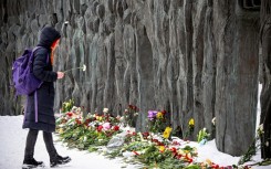 Some mourners gathered at a monument to victims of Soviet-era repression known as the 'Wall of Grief'