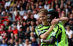 Arsenal's Martin Odegaard (L) and Bukayo Saka are dreaming of Champions League and Premier League glory